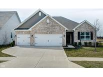 Beautiful single-story home with a three car garage and a well-manicured lawn at 3581 Free Spirit Ct, Westfield, IN 46074