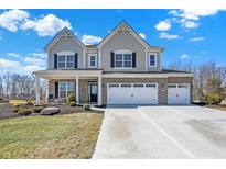 Charming two-story home featuring a three-car garage and well-manicured front lawn at 4052 Saddle Club S Pkwy, Bargersville, IN 46106