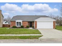Charming brick ranch with attached two-car garage and well-manicured front lawn at 4210 Ansar Ln, Indianapolis, IN 46254