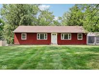 Charming home with a red exterior, well-maintained lawn, and a inviting white front door and trim at 4754 E 64Th St, Indianapolis, IN 46220