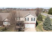Two-story home with light beige siding, black shutters, and a brick front, plus an attached garage at 5944 Edelle Dr, Indianapolis, IN 46237