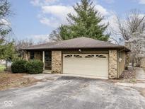 Charming single-story home with a stone facade and a two-car garage on a sunny day at 8390 Central Ave, Martinsville, IN 46151