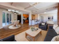 Open-concept living room boasts hardwood floors, modern furniture, and a view to the outdoor patio at 110 E Washington St # 802, Indianapolis, IN 46204