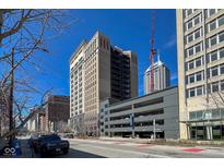 An eye-level street view showcasing the building's architecture and urban setting on a sunny day at 110 E Washington St # 802, Indianapolis, IN 46204