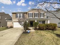 Charming two-story home boasts well-maintained landscaping, attached garage, and inviting curb appeal at 12416 Teacup Way, Indianapolis, IN 46235