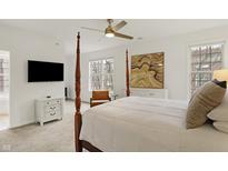 Spacious bedroom with a four-poster bed, mounted TV, and large windows at 226 N Cleveland St # 226E, Indianapolis, IN 46204