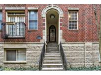A charming brick apartment building features a private entrance with a small staircase and an arched entryway at 226 N Cleveland St # 226E, Indianapolis, IN 46204