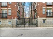 Apartment building with iron gates and a landscaped courtyard; perfect for urban living at 226 N Cleveland St # 226E, Indianapolis, IN 46204