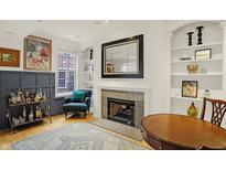 A comfortable living room with a fireplace, built-in shelves, and elegant decor is shown in this interior shot at 226 N Cleveland St # 226E, Indianapolis, IN 46204