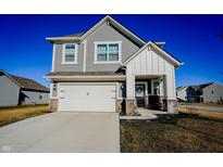 Charming two-story home with gray siding, white trim, and a two-car garage under a clear blue sky at 2349 Dixon Creek Dr, Whitestown, IN 46075