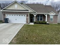 Charming single-story home featuring a well-maintained lawn, two-car garage, and inviting front porch at 2536 Lanai Ln, Greenwood, IN 46143