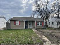 Cozy home with neutral siding, red shutters, and a small front yard at 2813 Baltimore Ave, Indianapolis, IN 46218