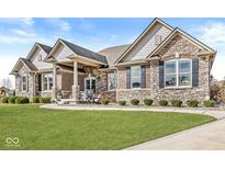 Charming single-Gathering home with a beautifully manicured lawn and attractive stone and brick exterior at 3342 Challenger Dr, Plainfield, IN 46168