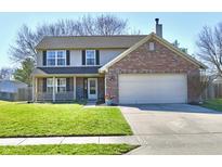Two-story home featuring a brick-accented garage, front porch, and well-maintained lawn at 576 Port Dr, Avon, IN 46123