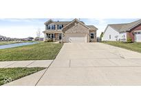 Charming two-story home with brick facade, wide driveway, and landscaping at 5806 Belvista Dr, Plainfield, IN 46168