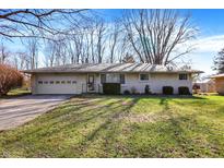 Charming ranch-style home featuring a one car garage, light brick, and well maintained lawn and landscape at 7133 Mc Lain Dr, Indianapolis, IN 46217