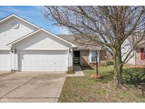 Charming single-story home featuring a two-car garage, brick accents, and a well-maintained front yard at 7164 Long Shore Cir, Indianapolis, IN 46217