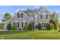 Inviting two-story home with manicured lawn, stone accents, and symmetrical design at 7845 W Hillside Dr, Columbus, IN 47201