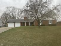 Charming brick home with attached two car garage and spacious front yard at 805 Stewart Rd, Anderson, IN 46012