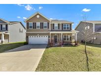 Inviting two-story home with a well-manicured lawn and attached two-car garage at 8153 Fivespot Ln, Plainfield, IN 46168
