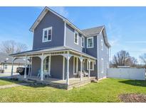 Charming two-story home with a covered front porch and gray siding at 97 N Maple St, Pittsboro, IN 46167