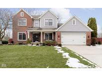 Charming two-story home featuring brick accents, gray siding, and a well-manicured lawn at 10050 Walthan Way, Fishers, IN 46037