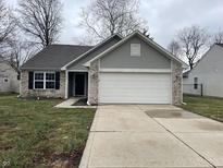 Charming single-story home featuring a two-car garage and neutral exterior at 125 Hilltop Farms Blvd, Whiteland, IN 46184