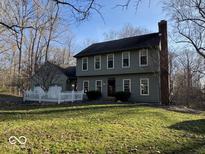 Charming two-story home features a traditional design with well-maintained landscaping, and a classic white picket fence at 155 Boring Pl, Martinsville, IN 46151