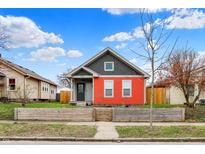 Charming home featuring a well-kept front yard and a colorful two-tone exterior at 1715 E Kelly St, Indianapolis, IN 46203