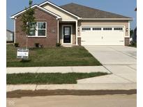 Charming single-story home with brick and vinyl siding, a well-manicured lawn, and an attached two-car garage at 2152 Foothill Dr, Greenfield, IN 46140