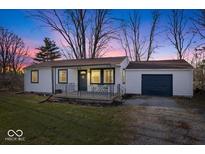 Charming home featuring a manicured lawn, covered porch, and an attached garage, great for outdoor entertaining at 300 Indiana Ave, Pendleton, IN 46064