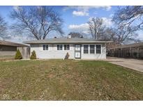 Charming single-story home featuring gray siding, white trim, and a well-maintained lawn on a sunny day at 3109 Welch Dr, Indianapolis, IN 46224
