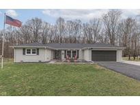 Charming single-story home with a well-manicured lawn, gray brick, and an attached garage at 3576 E Rembrandt Dr, Martinsville, IN 46151