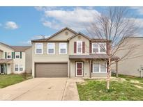 Charming two-story home with a well-manicured lawn and a two car garage at 366 Springfield Cir, Greenwood, IN 46143