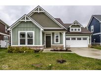 Charming single Gathering home showcasing green siding and a well-manicured front lawn at 401 Thomas Point Dr, Fortville, IN 46040