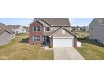 Two-story home featuring a two-car garage, brick accents, and manicured front lawn at 4213 Katie Ln, Indianapolis, IN 46239