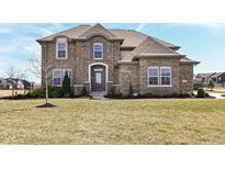 Charming two-story brick home with a manicured front yard and inviting entrance at 4255 Kettering Dr, Zionsville, IN 46077