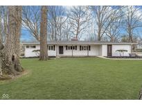 Charming single-story home with a well-manicured lawn and inviting covered entry at 4390 Manning Rd, Indianapolis, IN 46228