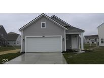 Charming home featuring a gray exterior, white garage door and front door, with fresh landscaping at 5138 Modernist Blvd, Indianapolis, IN 46237