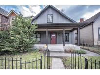 Charming home featuring a welcoming front porch and nicely landscaped yard at 615 E Morris St, Indianapolis, IN 46203