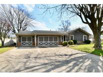 Charming single story home features a two car garage, large driveway and well maintained front yard at 695 Valley Oaks Rd, Greenwood, IN 46143