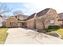 Beautiful brick home with a spacious driveway and two-car garage offering ample parking and curb appeal at 14365 Laura Vista Dr, Carmel, IN 46033