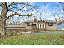 Charming ranch-style home with brick and siding exterior, complemented by a well-maintained front yard at 381 Redbud Pl, Greenwood, IN 46142
