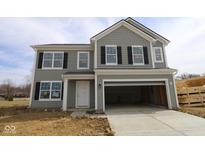 Charming two-story home with gray siding, black shutters, an attached garage, and a well-manicured lawn at 3913 Highcrest Rd, Indianapolis, IN 46239