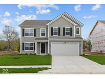 Charming two-story home featuring gray siding, black shutters, a two-car garage, and a well-manicured lawn at 3913 Highcrest Rd, Indianapolis, IN 46239