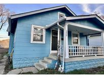 Charming blue house featuring a covered front porch, offering curb appeal and a welcoming entrance at 3932 Caroline Ave, Indianapolis, IN 46205