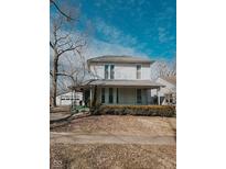 Charming two-story home with a covered front porch, mature landscaping, and a detached garage, offering classic appeal at 50 N Edwards St, Franklin, IN 46131