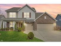 Charming two-story home with a large front yard, two-car garage and covered porch at 5540 Arrowgrass Ct, Noblesville, IN 46062