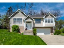 Charming home with two-car garage, white trim, front lawn, and well-maintained landscaping at 5836 Andover Rd, Indianapolis, IN 46220