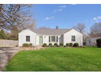 Charming single-story home with a well-manicured lawn and a welcoming green front door at 6721 Evanston Ave, Indianapolis, IN 46220